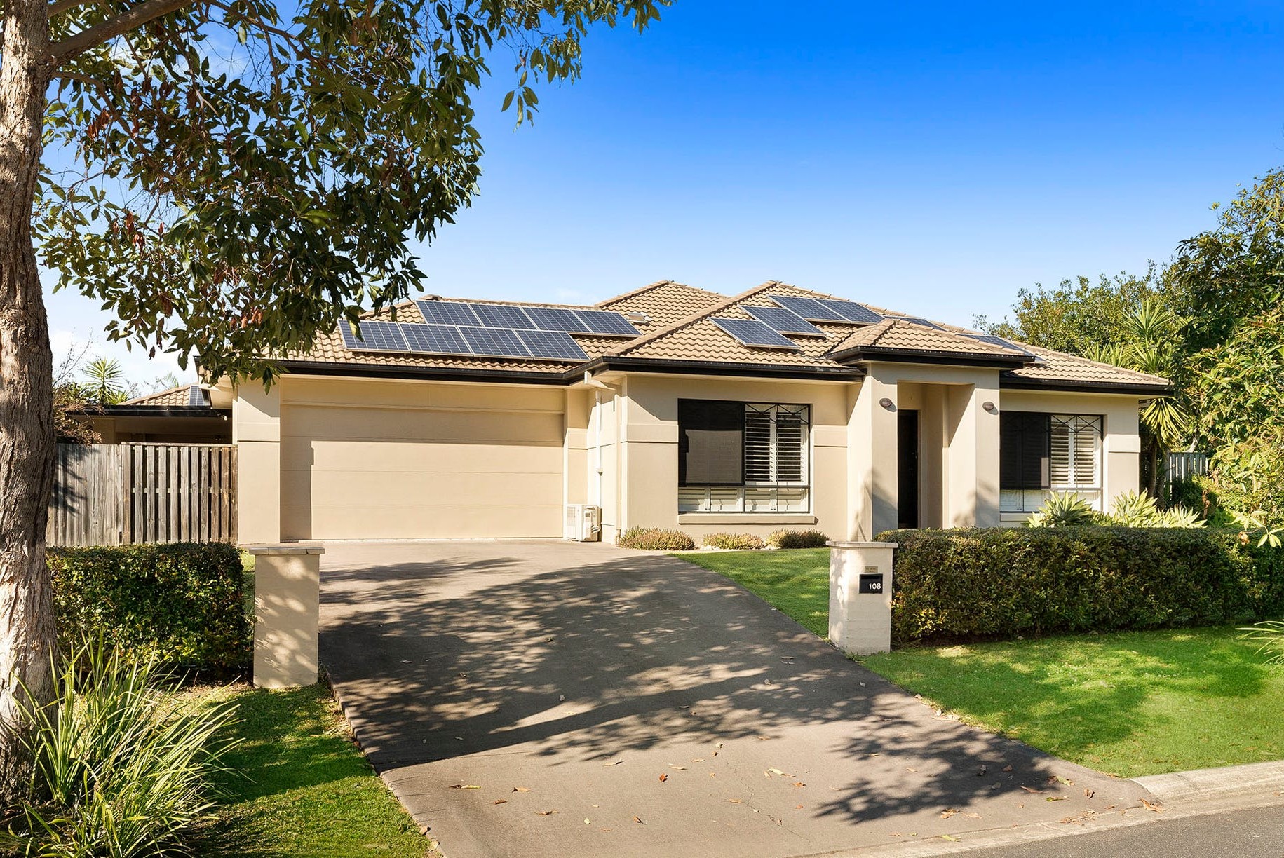 Front of the respite house, with a driveway, garden and solar panels on the roof