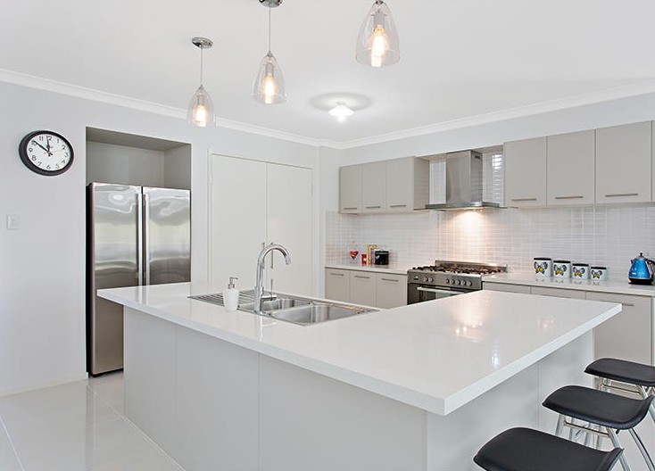 Kitchen in SIL home 1, with a large island bench, breakfast bar and stainless steel appliances
